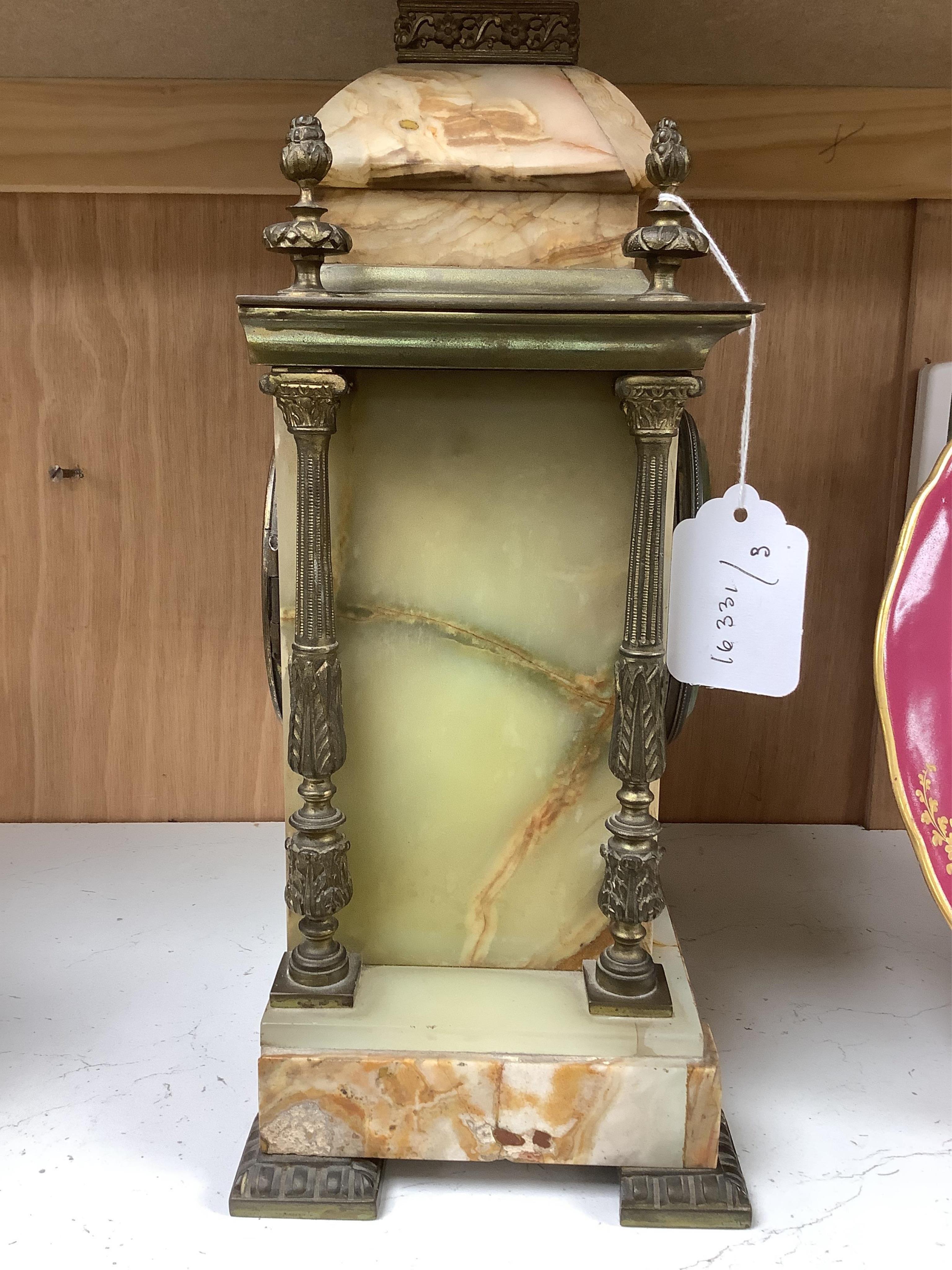 An early 20th century marble and onyx mantel clock with enamel dial with pendulum, no key, 32cm high. Condition - fair, untested